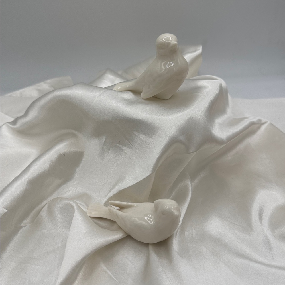 White porcelain bird figurines are vintage from the Lenox Bird Collection.